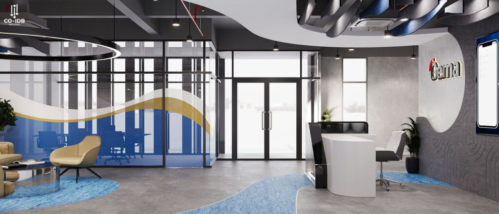 Khu vực lễ tân nổi bật với quầy cong hiện đại, kết hợp sàn trải vinyl vân sóng và vách kính in đồ họa, phản ánh hình ảnh chuyên nghiệp – sáng tạo